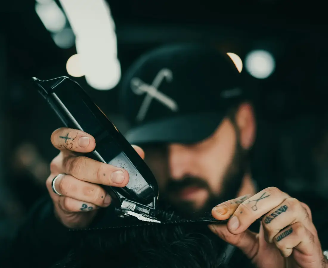 A CUTSTATE demo barber cutting a client's hair with clippers